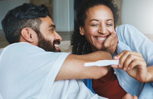 image depicting couple with a pregnancy test